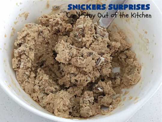 Snickers Surprises | Can't Stay Out of the Kitchen | these scrumptious #PeanutButterCookies include #SnickersBars so they have a little bit of #caramel, #chocolate & #PeanutButter in every bite. You're sure to swoon once you get a taste of these jewels. Perfect for #tailgating, potlucks, backyard BBQs and #holiday #baking. #ChristmasCookieExchange #dessert #ChocolateDessert #SnickersDessert #PeanutButterDessert #CaramelDessert #cookies #SnickersSurprises