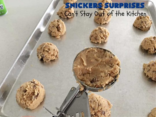 Snickers Surprises | Can't Stay Out of the Kitchen | these scrumptious #PeanutButterCookies include #SnickersBars so they have a little bit of #caramel, #chocolate & #PeanutButter in every bite. You're sure to swoon once you get a taste of these jewels. Perfect for #tailgating, potlucks, backyard BBQs and #holiday #baking. #ChristmasCookieExchange #dessert #ChocolateDessert #SnickersDessert #PeanutButterDessert #CaramelDessert #cookies #SnickersSurprises
