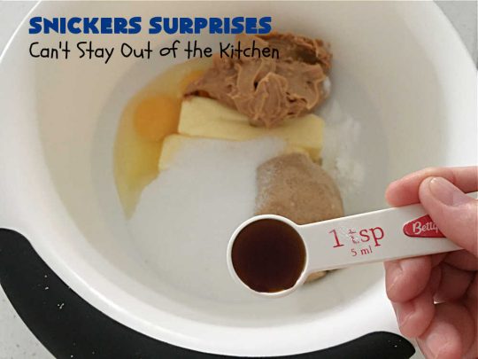 Snickers Surprises | Can't Stay Out of the Kitchen | these scrumptious #PeanutButterCookies include #SnickersBars so they have a little bit of #caramel, #chocolate & #PeanutButter in every bite. You're sure to swoon once you get a taste of these jewels. Perfect for #tailgating, potlucks, backyard BBQs and #holiday #baking. #ChristmasCookieExchange #dessert #ChocolateDessert #SnickersDessert #PeanutButterDessert #CaramelDessert #cookies #SnickersSurprises