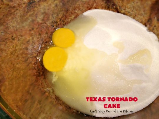 Texas Tornado Cake | Can't Stay Out of the Kitchen | this quick & easy #cake #recipe looks like a tornado hit it after baking! It's filled with #walnuts and #FruitCocktail. The #caramelized icing contains #coconut. This vintage cake will knock your socks off! #dessert #TexasTornadoCake #FruitCocktailCake #peaches #pears #EasyDessertRecipe #Holiday #HolidayDessert #ValentinesDay #ValentinesDayDessert