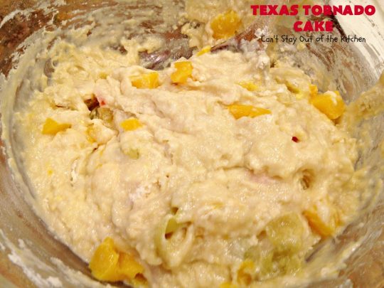 Texas Tornado Cake | Can't Stay Out of the Kitchen | this quick & easy #cake #recipe looks like a tornado hit it after baking! It's filled with #walnuts and #FruitCocktail. The #caramelized icing contains #coconut. This vintage cake will knock your socks off! #dessert #TexasTornadoCake #FruitCocktailCake #peaches #pears #EasyDessertRecipe #Holiday #HolidayDessert #ValentinesDay #ValentinesDayDessert