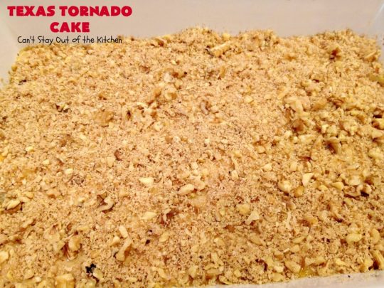 Texas Tornado Cake | Can't Stay Out of the Kitchen | this quick & easy #cake #recipe looks like a tornado hit it after baking! It's filled with #walnuts and #FruitCocktail. The #caramelized icing contains #coconut. This vintage cake will knock your socks off! #dessert #TexasTornadoCake #FruitCocktailCake #peaches #pears #EasyDessertRecipe #Holiday #HolidayDessert #ValentinesDay #ValentinesDayDessert